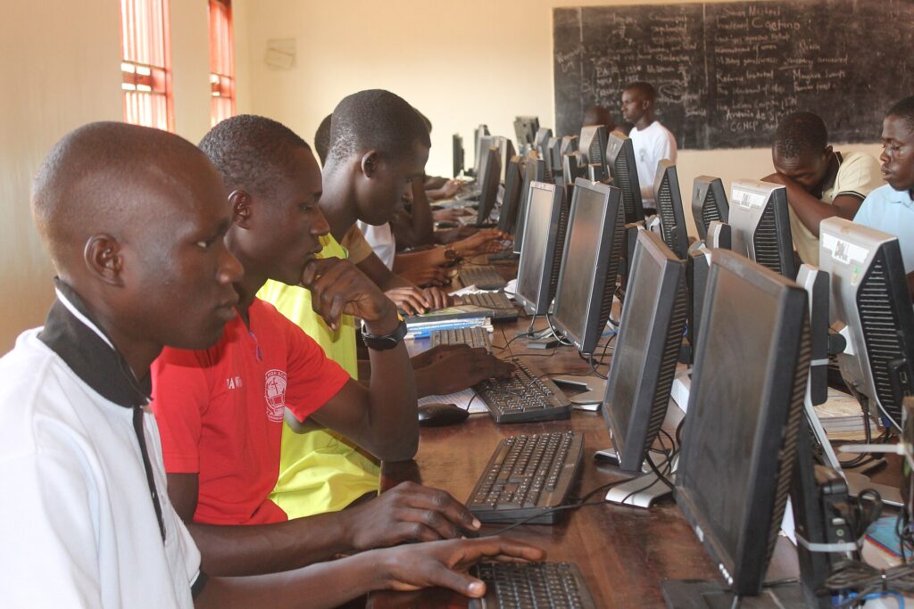 Students learning on computers in a Ugandan school